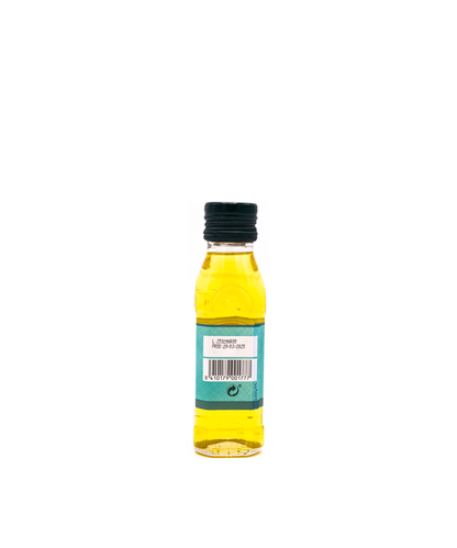 Small bottle of lemon juice with a black cap on a white background