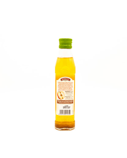 Bottle of apple cider vinegar with a label on a white background